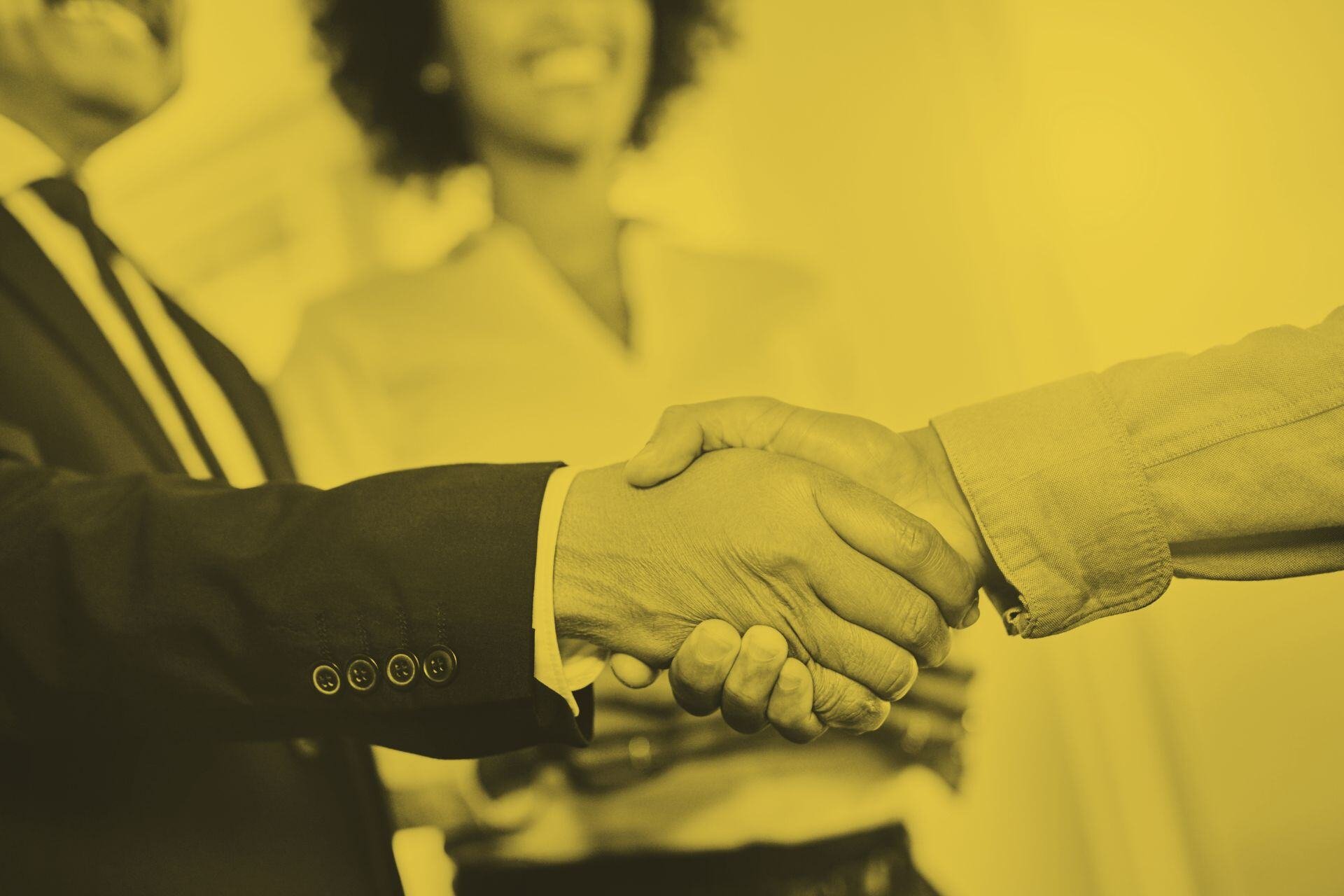 An employee and manager shaking hands during onboarding